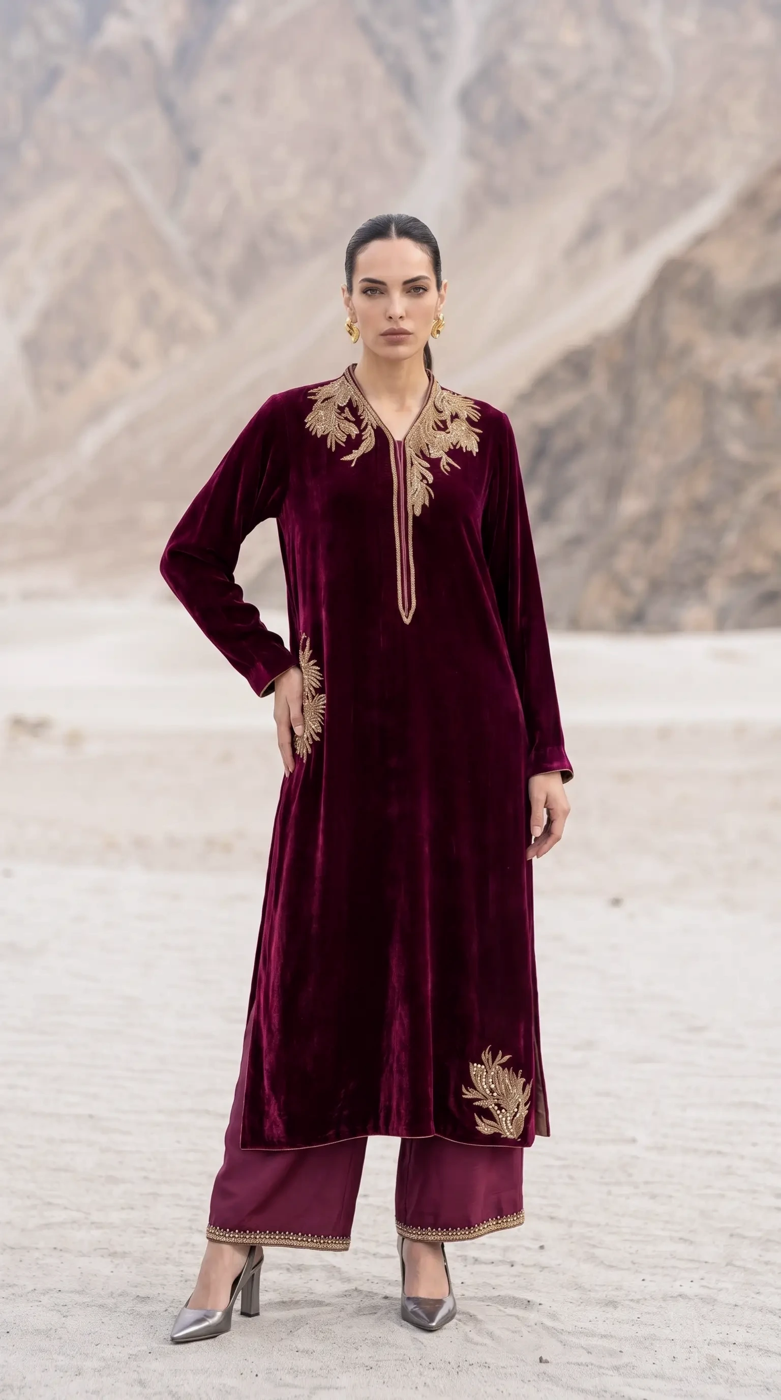 Three-quarter view of Merlot Aurelia showing its long velvet silhouette and asymmetric lower motif