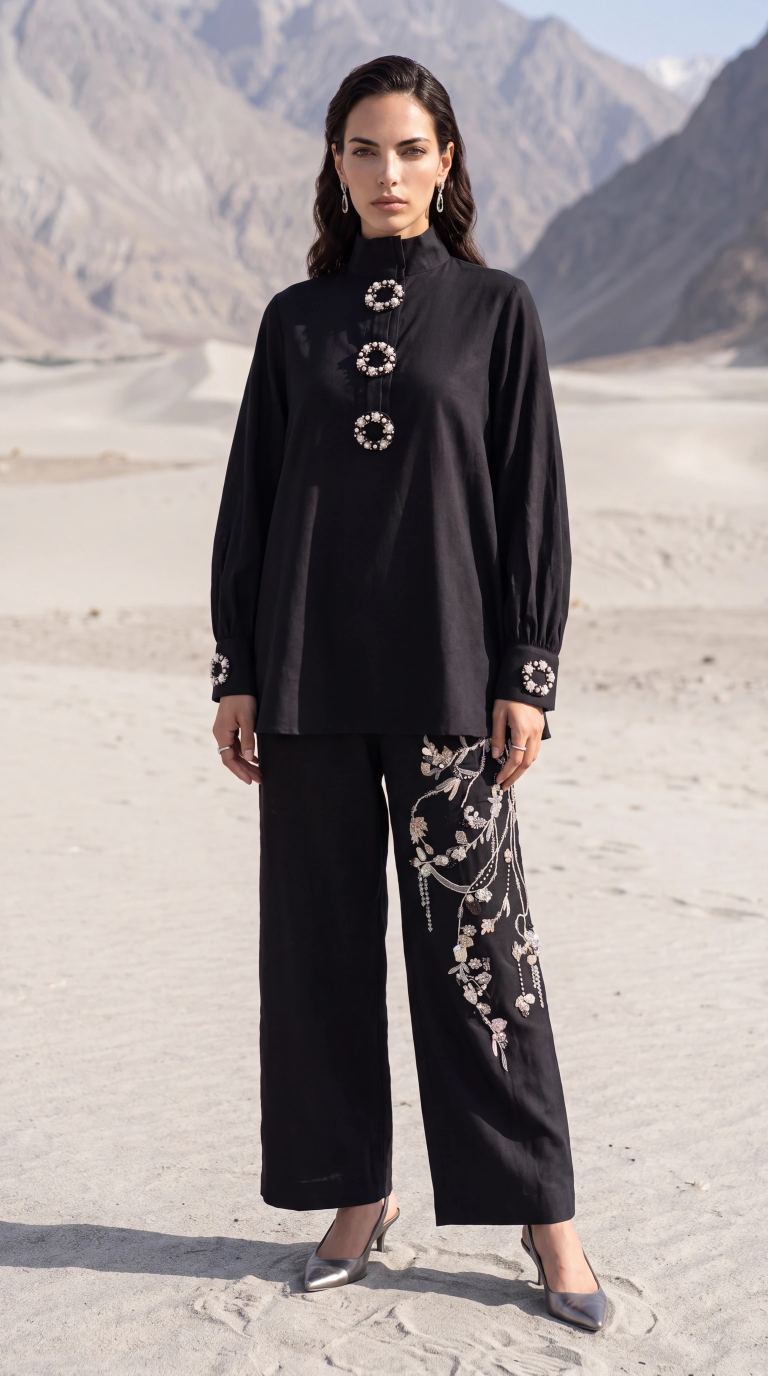 Full front view of Obsidian Halo with its jeweled circular closures and asymmetric trouser embroidery